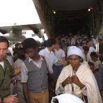An IDF officer helps Ethiopian immigrants off the plane during Operation Solomon | Photograph: Israeli Tsvika, GPO, May 1991. An IDF officer helps Ethiopian immigrants off the plane during Operation Solomon | Photograph: Israeli Tsvika, GPO, May 1991.