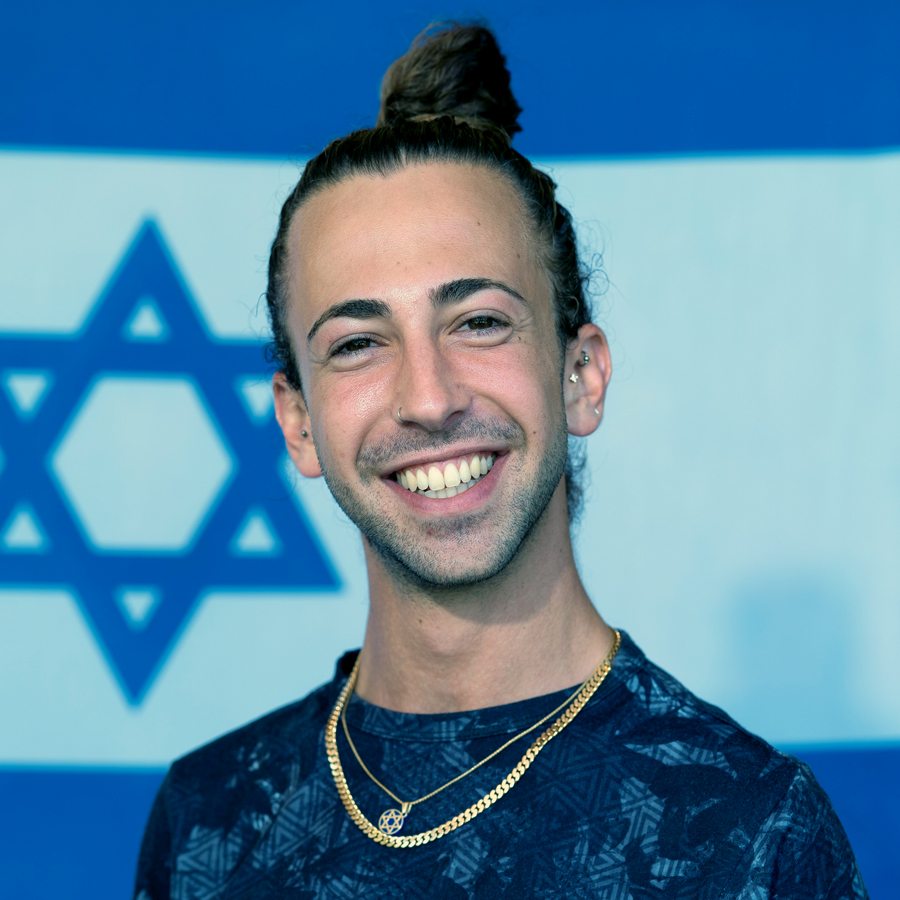 Yakov in front of an Israeli flag